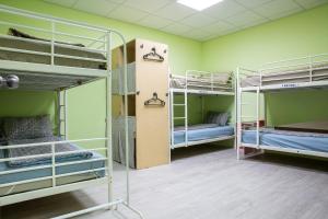 a room with three bunk beds in a room at 日月彩舟 日月潭背包客旅店 Sun Moon Lake Rainbow SUP Hostel in Yuchi