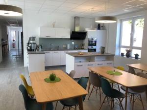 a kitchen and dining room with tables and chairs at Studio Emdecker am Delft in Emden