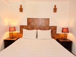 a bedroom with a large bed with two lamps at Casa da Mae in Salir +40 photos