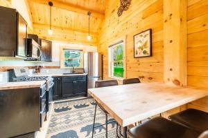a kitchen with wooden walls and a wooden table at Florida Mountain Log Cabin in Florida