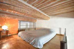 a bedroom with a bed and a wooden floor at Les Mats Du Port in Marseille