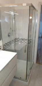a shower with a glass door in a bathroom at Family apartment in Riccione, free bikes in Riccione