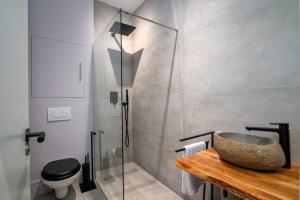 a bathroom with a glass shower and a stone sink at GuestReady - Luxury Central London Apartment in London