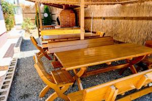 a wooden table and chairs sitting in a patio at Studio Bucuria Corbu in Corbu +3 photos