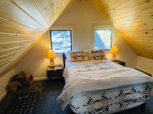 a bedroom with a large bed in a attic at Sled-Ski Lakeside Village Cabin - Spa - BBQ - Firepit - Loft - Games in Big Bear Lake