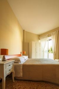 a bedroom with a large bed and a window at Trastevere Chic in Rome