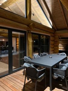 a patio with a table and chairs on a deck at Chalet Deux A in Bad Kleinkirchheim