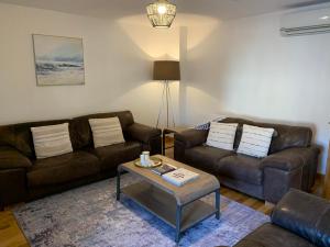 a living room with two couches and a coffee table at Orkney Staycations - Orcadale in Orkney