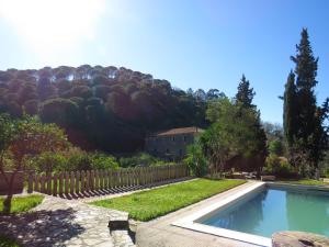 a swimming pool in a yard with a fence at One bedroom house with lake view shared pool and furnished garden at Porto de Mos in Porto de Mós