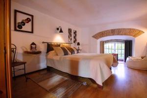 a bedroom with a large bed in a room at One bedroom house with lake view shared pool and furnished garden at Porto de Mos in Porto de Mós