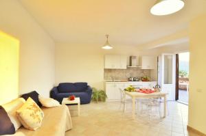 a living room with a blue couch and a table at Lemon Flats Sorrento in Sorrento