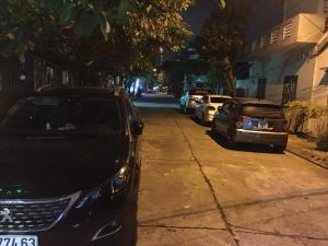 two cars parked on the side of a street at night at HANID Hotel in Tuy Hoa