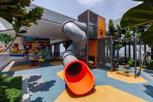 a playground in a house with a slide at Beacon Executive Suite by Fantabulous Guest House in George Town