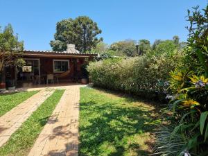 a house with a garden and a patio at Casa do Mato ! Lugar de descanso e Paz !-Next Iguassu Falls in Foz do Iguaçu