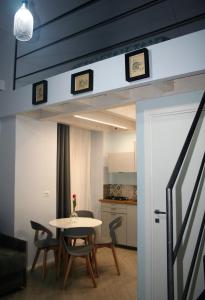 a room with a table and chairs and a kitchen at Valina Apartments in Catania