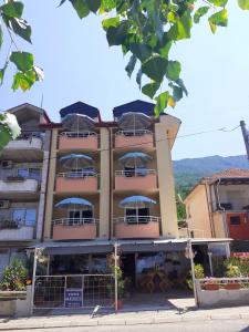 a building with balconies on the side of it at Apartmani BAKULE in Peštani
