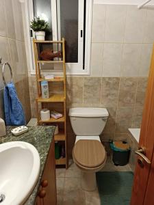 a bathroom with a toilet and a sink at EMPA SUNSET VIEWS VILLA in Emba