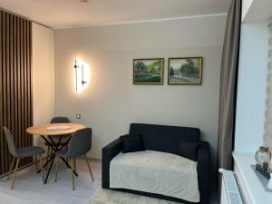 a living room with a table and a chair at Гірський Кришталь in Skole