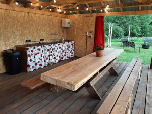 a wooden picnic table on a wooden deck at Suurepera puhkekeskuse saunamaja 