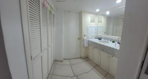 a white bathroom with a sink and a mirror at Beachfront view Condo beside la Isla Mall in Puerto Vallarta +14 photos