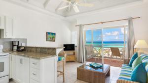 a kitchen and living room with a view of the ocean at Shoal Bay Villas in Shoal Bay Village