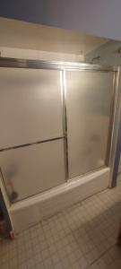 a sliding glass door in a kitchen with a tile floor at Zen Hostel in Toronto +4 photos