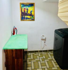 a room with a table and a painting on the wall at Lovely Studio apartment at Ajah - Maria in Iranla