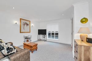 a living room with a couch and a tv at 10 St Edmundsbury Mews in Bury Saint Edmunds