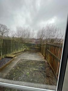 a view from a window of a yard with a fence at Hensh Homes in Saint Helens
