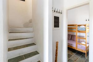 a hallway with stairs leading to a bedroom with bunk beds at Maison a la Plage in Faros