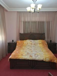 a bedroom with a bed with a yellow blanket on it at Dream Home in Amman