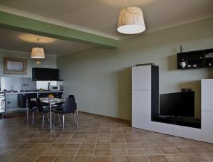 a kitchen and dining room with a table and a refrigerator at Casa Vacanza Cicirello in Giardini Naxos