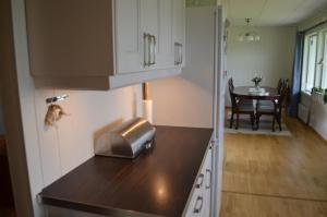 a kitchen with a counter top and a table at Apartament Sandstrand 