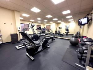 a gym with several exercise bikes and a television at Holiday Inn Express Hotel & Suites Barstow, an IHG Hotel in Barstow