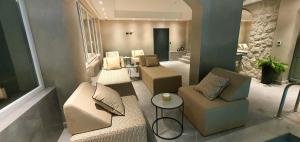 a living room with a couch and chairs and a table at Boutique Hotel Acacia in Lovran