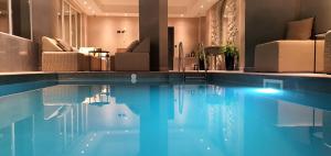 a large swimming pool with chairs at Boutique Hotel Acacia in Lovran