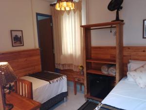 Cama ou camas em um quarto em Pousada Caminhos de Minas Belo Horizonte