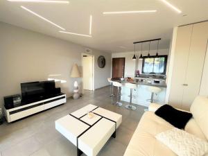 sala de estar con sofá blanco y cocina en Appartement Porticcio, 2 pièces, 4 personnes - FR-1-61-600, en Grosseto-Prugna