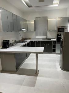 a large kitchen with a table in the middle at Amazing apartment in Riyadh
