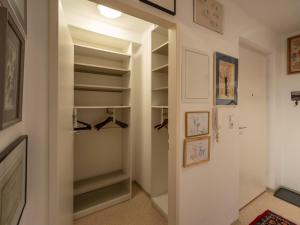 a walk in closet with glass doors and shelves at Appartement Gernot in Kirchberg in Tirol