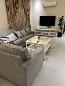a living room with a couch and a coffee table at Amazing apartment in Riyadh