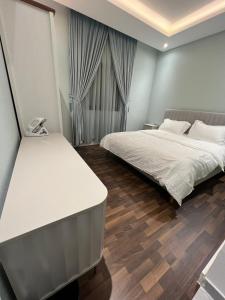 a bedroom with two beds and a phone in it at Amazing apartment in Riyadh