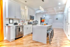 a kitchen with white cabinets and a white counter top at Lux Apt in Bronzeville, Min from Downtown-RSV Now! in Chicago