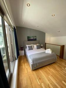 a bedroom with a bed and a wooden floor at A beautiful and cozy home in the heart of london in London