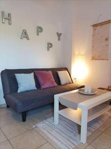 a living room with a couch and a coffee table at Comfy Cozy Iksia in Ixia