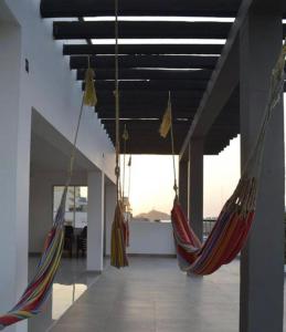 two hammocks hanging from the ceiling in a room at Hotel Cangrejalito in Santa Marta