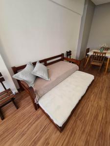 a large bed in a room with a wooden floor at Petrópolis. Centro in Petrópolis