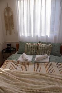 a bedroom with a large bed with a window at Bohome apartman - FREE PARKING in Vranje