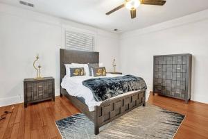 a bedroom with a bed and two night stands at Exquisite two-story home located in Midtown in Memphis