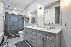 a white bathroom with a sink and a toilet at Exquisite two-story home located in Midtown in Memphis